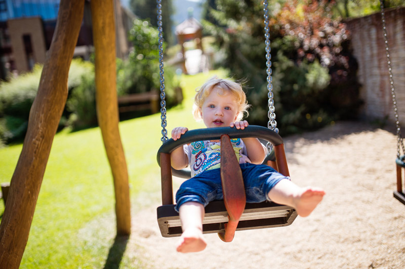 Little Boy On The Swing At The Playground Pz5dnsw.jpg